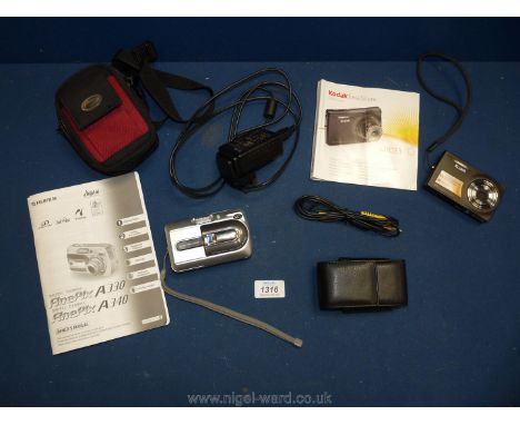 A Fujifilm Fine Pix digital camera and a Kodak easy share camera with instructions.
