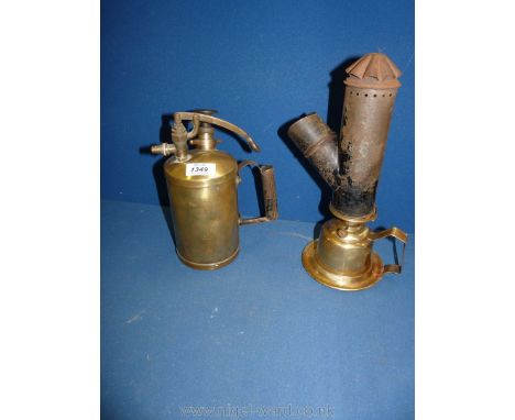 A brass spray, 9'' tall and a Brass wall hanging oil Lamp with metal chimney incorporating a magnifying lens, 12'' tall