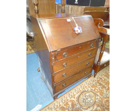 A compact mahogany Bureau, the slope opening to reveal a fitted interior with pigeonholes and two small drawers. The base wit
