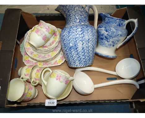 A Foley part Teaset with cream ground and pansies border (some hairline cracks), two Netherlands ceramic ladles and two blue 