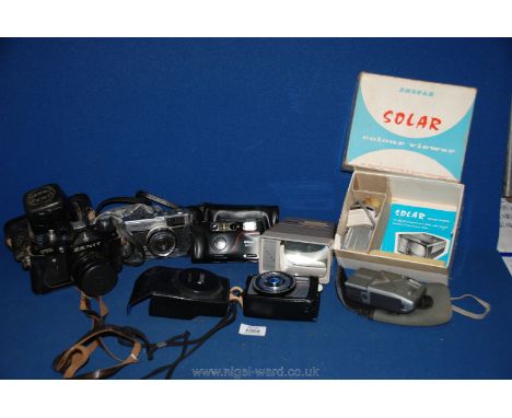 A quantity of SLR film cameras including a Zenit TTL, Olympus trip 35, Nikon RF10, Solar Colour Viewer and Luna 6 F Light Met