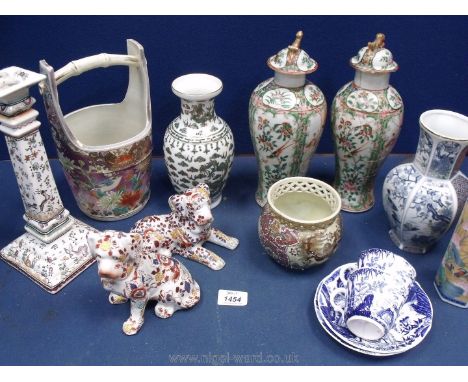 A quantity of oriental china including well bucket, candlestick, bowl, dogs, etc.