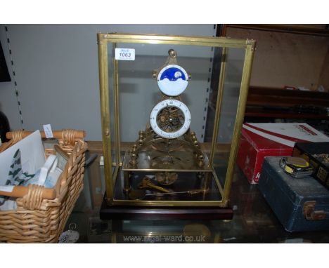 A heavy Brass Skeleton Clock having 3 3/4'' diameter enamelled chapter ring with Arabic numerals and with subsidiary moon pha