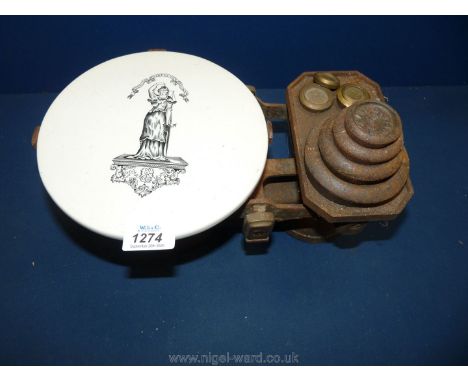A cast iron weighing scales and weights with a white stoneware base and painted lady detail.