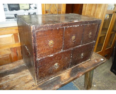 An uncommon Oak Campaign Chest having three small above two larger drawers with brass floriate back drop ring handles, the re