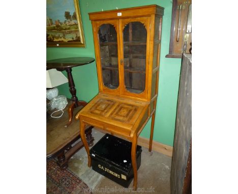An arts and crafts type Bureau Bookcase of compact dimensions, the lift-up hinged slope having a parquetry type surface and r