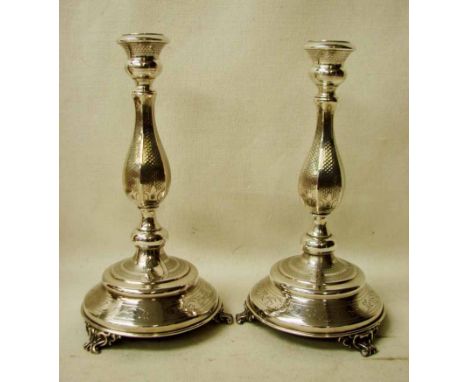 A pair of Austro Hungarian 800 grade silver Candlesticks of hexagonal baluster form on turned stepped bases supported on thre