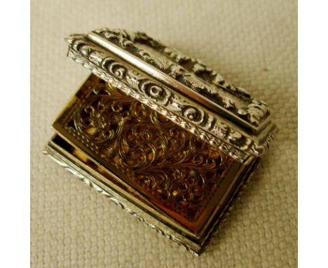 An  early Victorian silver Vinaigrette of rectangular form with hinged lid and pierced gilt grille, gilt interior, repousee d