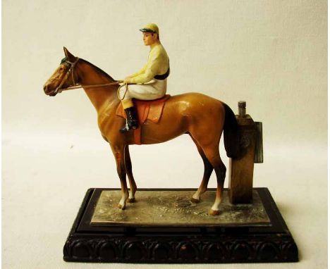 An early 20th century cold painted spelter model of a Horse and Jockey as a Table Lighter, with integral striker, on a polish