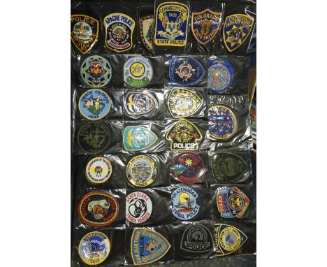 FOLDER OF 87 POLICE FORCE CLOTH PATCH BADGES. US INDIAN & TRIBAL 