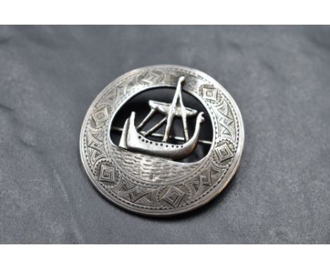 An Iona silver brooch of Celtic design having Viking ship detail within an engraved border and bearing name J Collie Iona to 