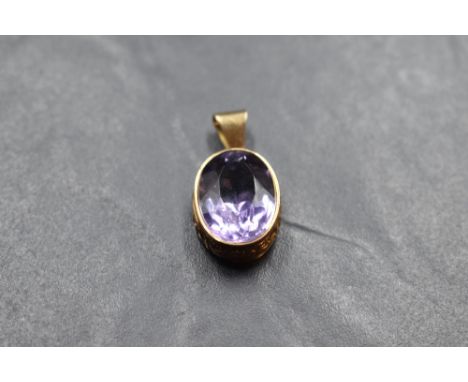An oval amethyst pendant in a 9ct rose gold collared mount with moulded decoration, no chain, approx 4.9g