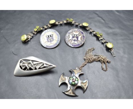 A small selection of silver and white metal jewellery including two Leeds hospital nursing brooches, a Caithness glass pendan