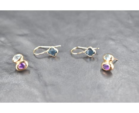 A pair of 9ct gold stud earrings having blue topaz and amethyst decoration and a pair of 9ct loop earrings having facet cut b