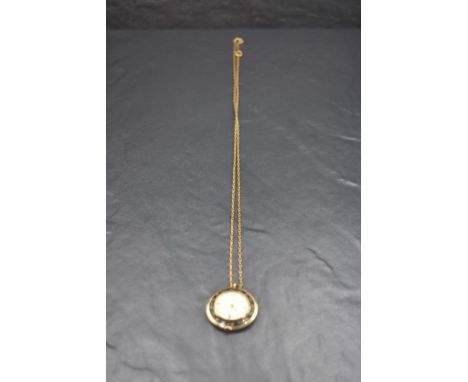 A vintage ladies 1960's yellow metal Oris pendant watch and yellow metal chain, of circular form with black enamelled detail 