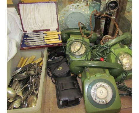 Three green bakelite telephones together with a partial candlestick telephone, cameras, flatwares etc