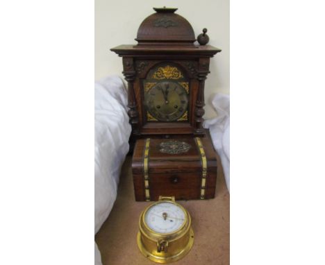 An oak mantle clock with a domed top above a silvered dial with Roman numerals, together with a Victorian rosewood two divisi