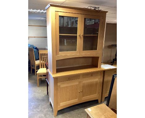 Mark Elliot Furniture light oak two height cabinet, with two glazed doors above, recess, two drawers and two panelled doors b