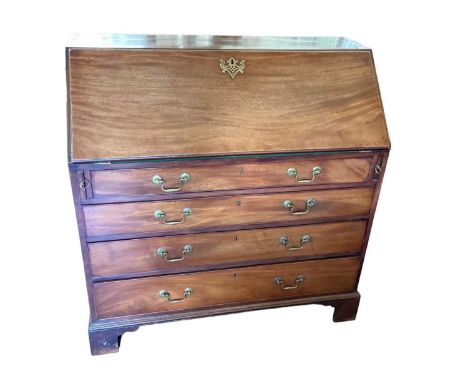 George III mahogany bureau, with fitted interior of short drawers and pigeon holes, and having four long graduated drawers be