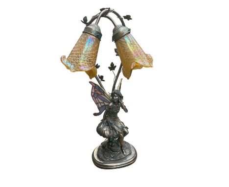 Tiffany style table lamp with two iridescent glass shades and stained glass wings to the bronzed resin fairy.