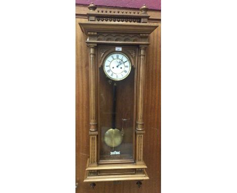 19th Century Vienna Regulator wall clock with pendulum and two brass cased weights in walnut case with turned colonnade pedim