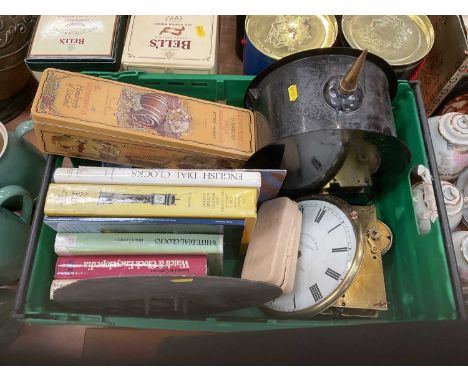 One box containing a collection of assorted clock parts and related reference books.