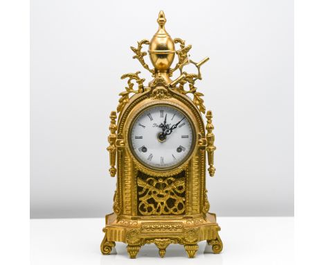 A brass mantle clock with bell strike and movement marked 'Fans Hallan' height 36cm with key.