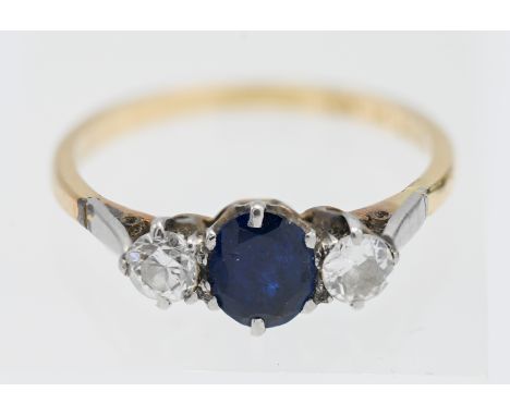 An 18ct platinum and sapphire and diamond set three stone ring