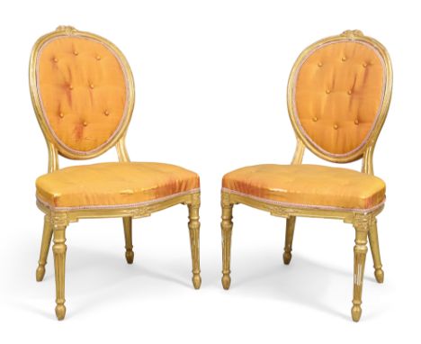 A pair of George III giltwood side chairs, last quarter 18th century, in the French taste, with button back silk upholstery, 