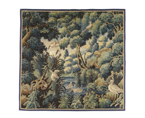 A Flemish verdure tapestry fragment, 17th century, depicting a central lake with bull rushes, surround by birds, a coiling se
