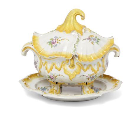 A Höchst fayence Rococo tureen, cover and stand, c.1750, the stand with black wheel/G. mark, the tureen moulded with a penden
