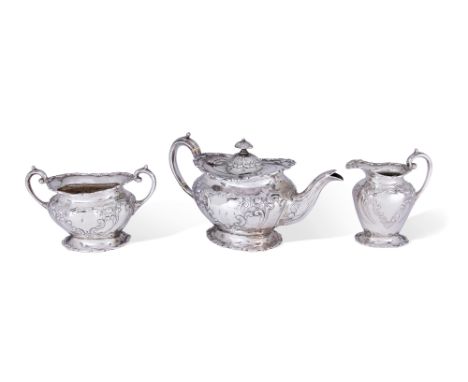 A Scottish silver three piece bachelor's tea set, Glasgow, 1904, George Edward & Sons, the oval rims and feet decorated with 