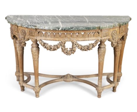 A French beechwood bow front console table, in the Louis XVI style, last quarter 19th century, the marble top above carved fr