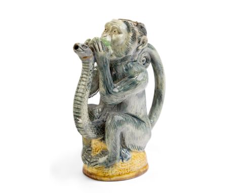 A Portuguese majolica monkey-form teapot, c.1885, attributed to Manuel Cipriano Mafra, Caldas, modelled seated astride a moun