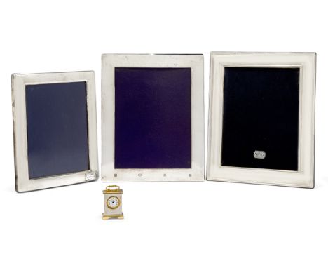 Three silver mounted photo frames, and a small clock, the frames hallmarked Sheffield, 2000, Carr's of Sheffield, 20.8 x 25.5
