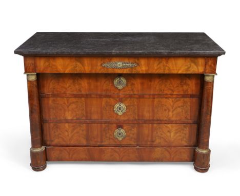 An Empire figured mahogany commode, second quarter 19th century, gilt metal mounted, the black marble top above five drawers,