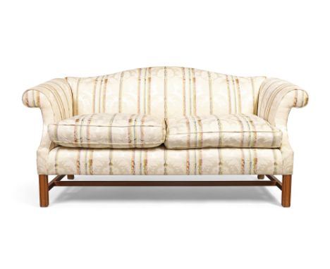 An English mahogany framed camel back sofa by Sinclair Melson Ltd, in the George III style, 20th century, with cream silk dam