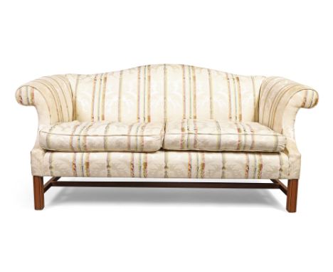An English mahogany framed camel back sofa by Sinclair Melson Ltd, in the George III style, 20th century, with cream silk dam