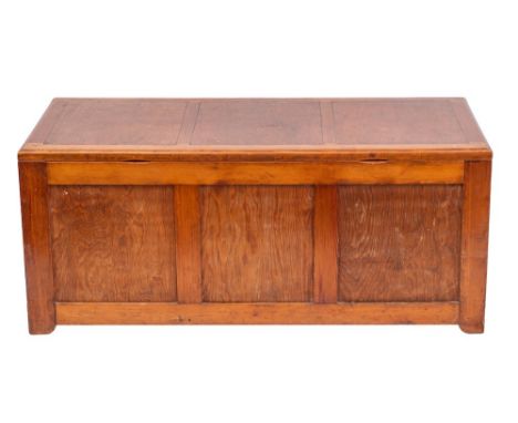 A pitch pine trunk, mid 20th century; the three panel hinged top above a conforming front, with twin elliptical apertures as 