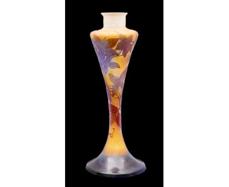 A Gallé cameo glass lamp base of slender waisted form the pale amber body overlaid with purple and acid etched with clematis-