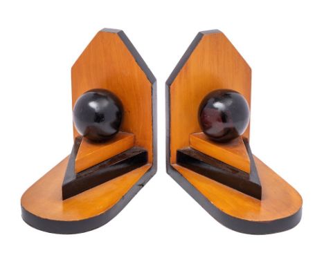 A pair of Art Deco period wood and ebonised book ends with circular globe raised on triangular stepped plinths on L-shaped ar