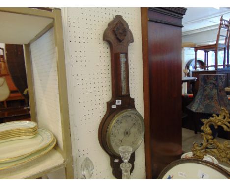 A carved Oak barometer