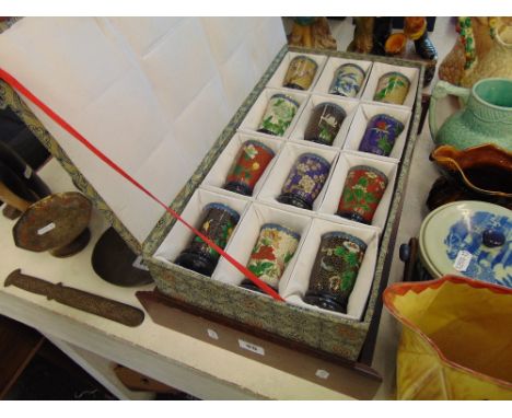 A boxed set of 12 miniature Cloisonne vases and display shelf