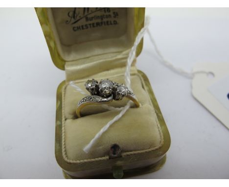 A Three Stone Diamond Ring, graduated claw set of crossover design, stamped "18ct &amp; PT" (finger size N) (2.6g), in a "A.W