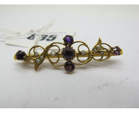 A 9ct Gold Amethyst Set Bar Brooch, of scroll design, graduated claw set, applied to plain bar, overall length 4.7cm (3.1g).