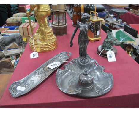 A W.M.F. Pewter Art Nouveau Ink Stand, mounted with a lady standing on a shaped circular base moulded with a sinuous design o