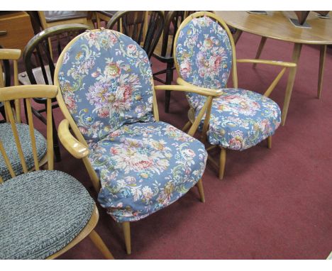 Ercol Pair of Low Easy Chairs, with spindle backs on splayed legs, bearing labels.