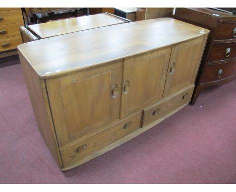 Ercol. Sideboard, with three cupboard doors over twin drawers, bow front base and top, 129cm wide.