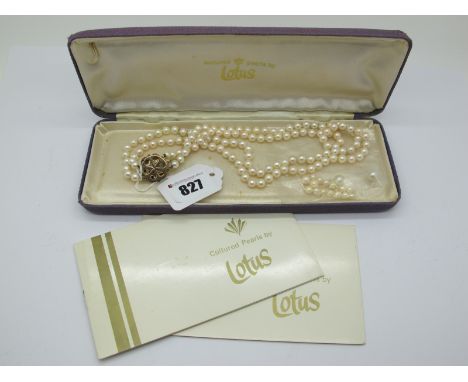 A Two Row Uniform Pearl Bead Necklace, knotted to a circular panel cluster clasp, graduated claw set, stamped "9ct".