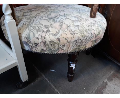 A ROUND FOOT STOOL WITH TURNED LEGS